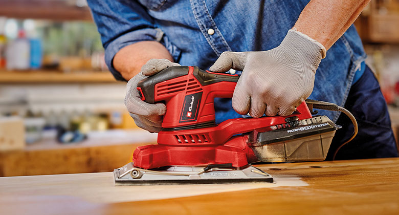 someone using orbital sander